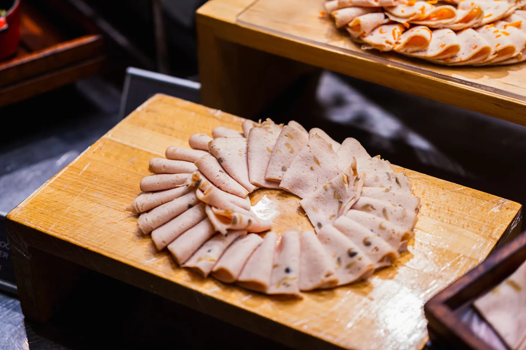 Sliced roasted meats arranged on a board